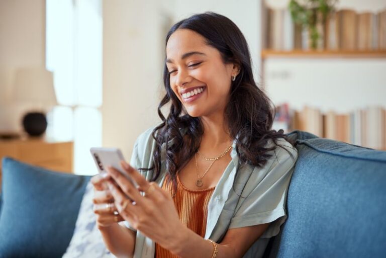 woman smiling using phone